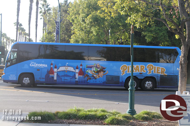 An airport bus sporting Pixar Pier graphics.