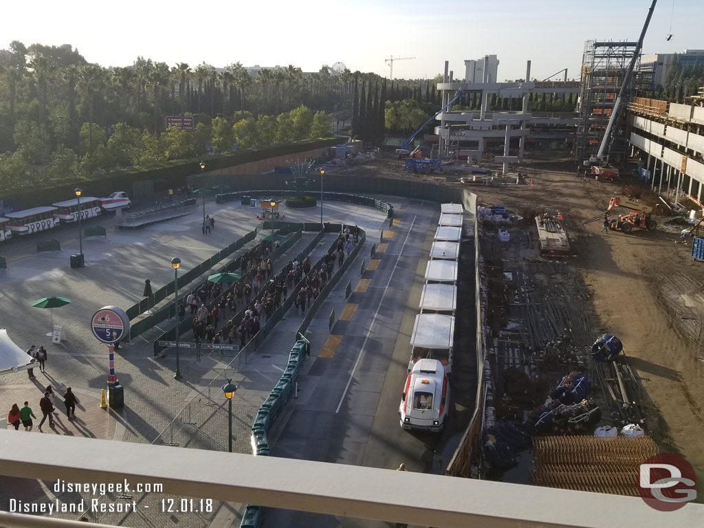 A wide view of the tram stop.  The queue is for guests heading toward security.