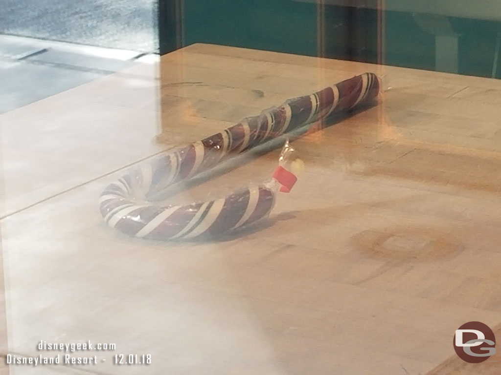 A finished candy cane on display in the Trolley Treats window.