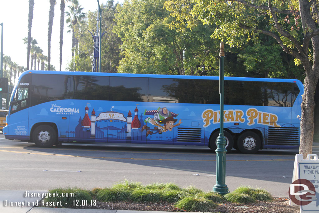 An airport bus sporting Pixar Pier graphics.