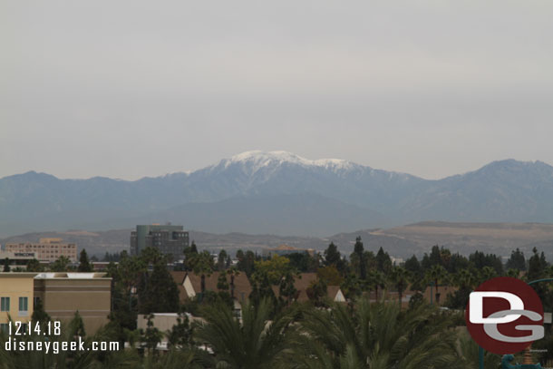 Some snow on the distant mountains visible from the roof.