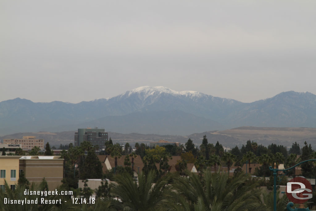 Some snow on the distant mountains visible from the roof.