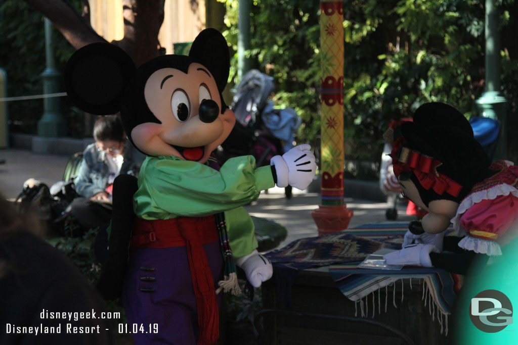 Mickey and Minnie signing autograph books at the Viva Navidad celebration.