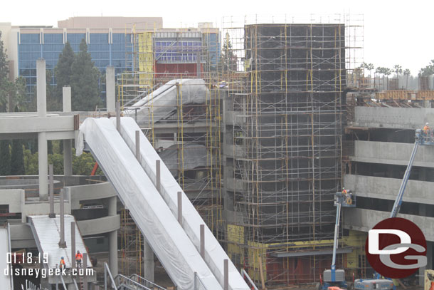 The two elevator structures are surrounded by scaffolding and are taking shape.