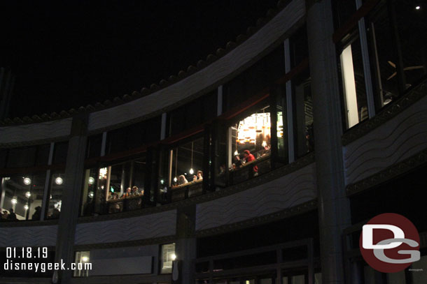 Guests sitting at a counter overlooking Downtown Disney.