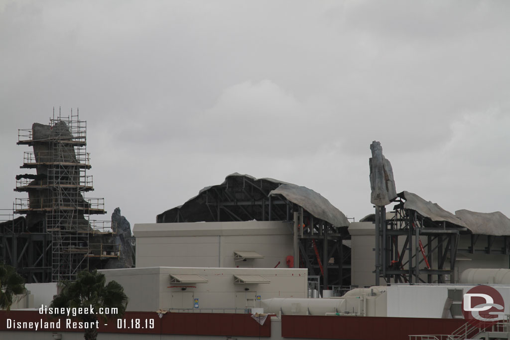 Several ladders up throughout the project and some workers underneath the formations.