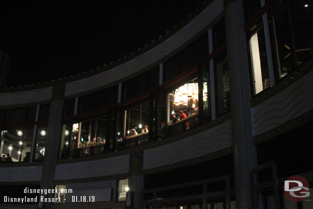 Guests sitting at a counter overlooking Downtown Disney.