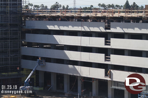 Panning across the structure.  Supports for the 6th floor/roof level are in place.  Crews are still working on the tram area facing side.