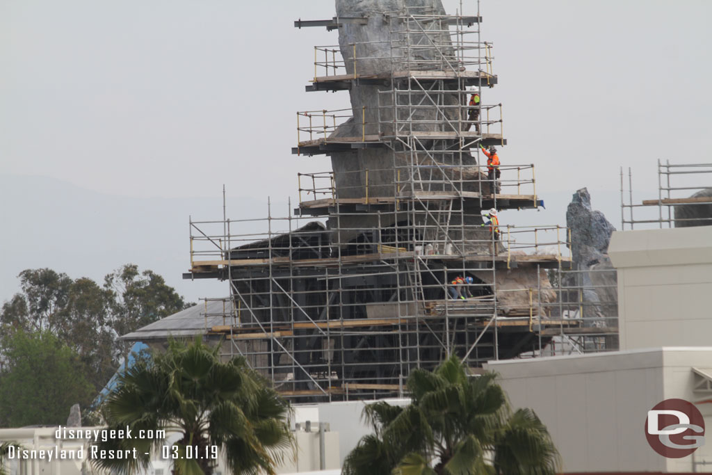 Teams stacking the scaffolding pieces as they hand them down.