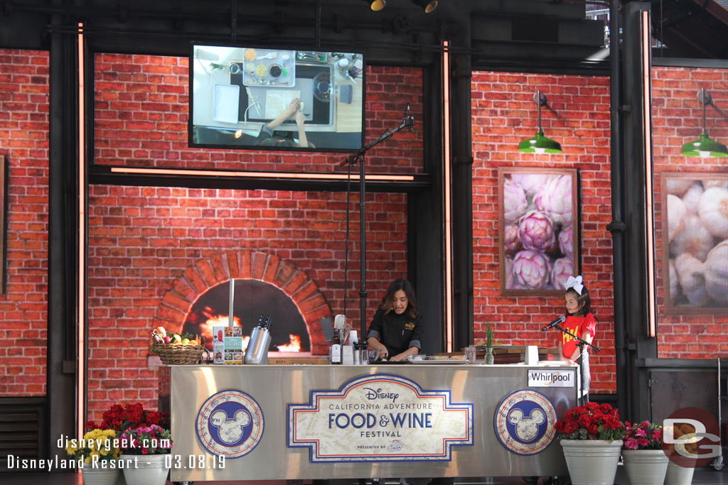 A chef leading a guest through a cooking demonstration.  They made three different snacks.