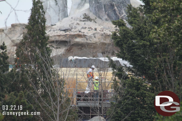 Through the trees you catch glimpses of crews finishing up buildings within Black Spire Outpost.