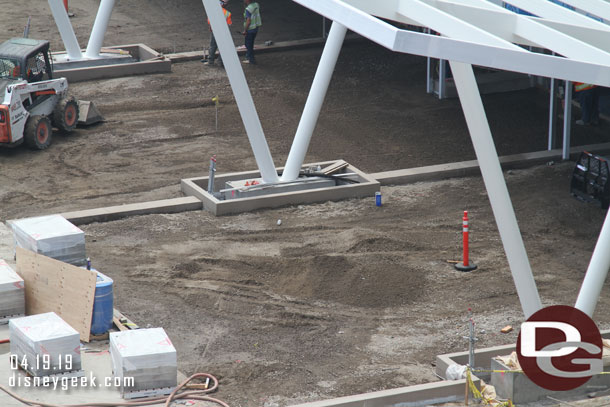 Hre you can see teams leveling off gravel and compacting it.  On the left are pavers on pallets.