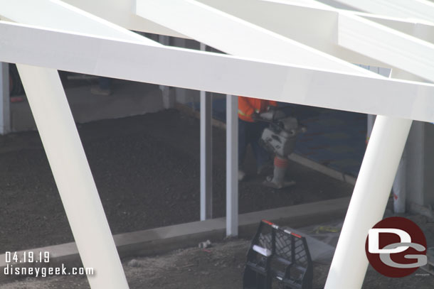 Here a worker is compacting the base material.  Beyond it you can see what appears to be pavers installed inside the structure.