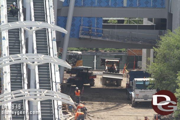 Crews working around the escalator area.