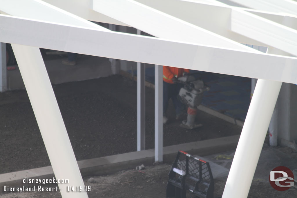 Here a worker is compacting the base material.  Beyond it you can see what appears to be pavers installed inside the structure.