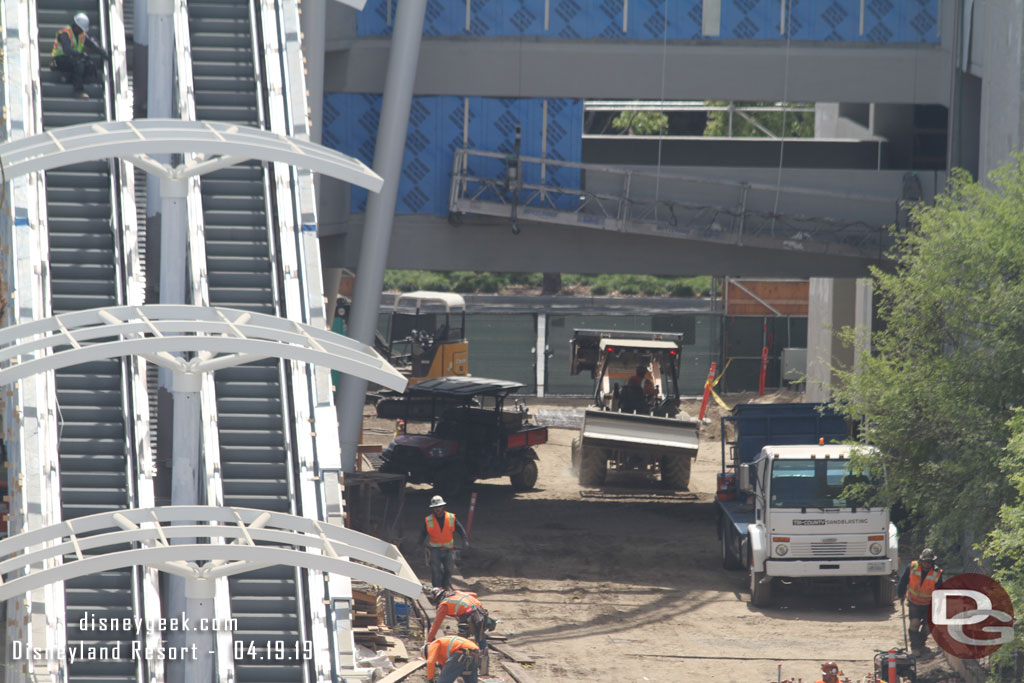 Crews working around the escalator area.