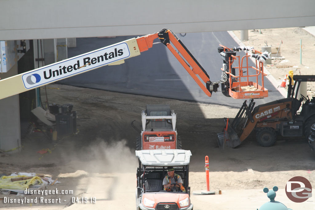 Blacktop has been laid on the driveway between the two structures.