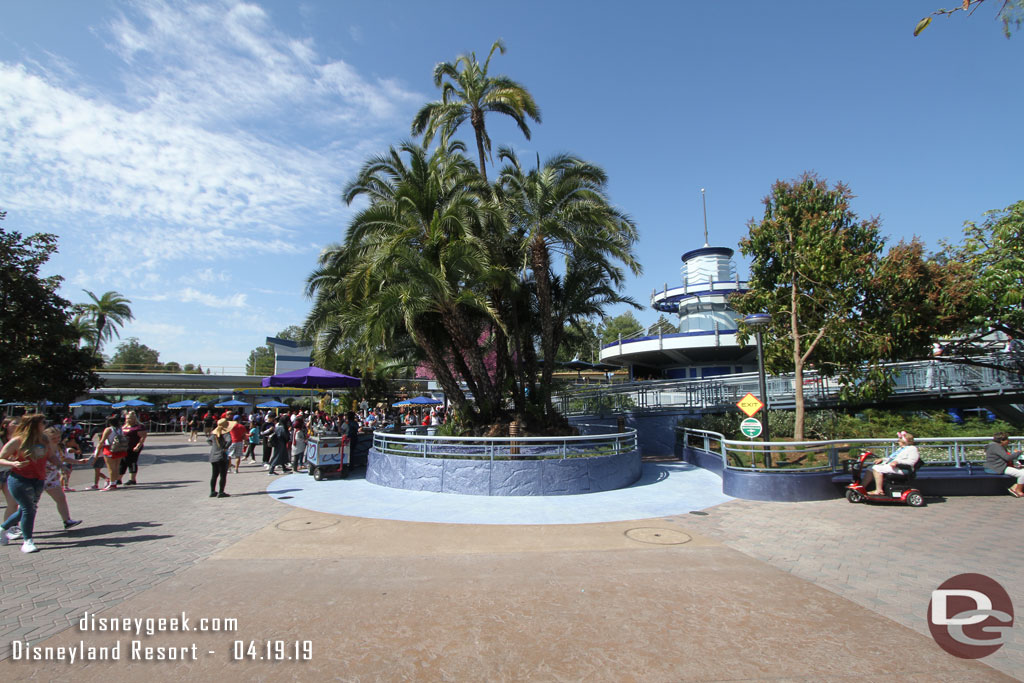 In Tomorrowland the walls are down from near the Autopia Exit.  The planter has been trimmed back and a new path behind it added.  Here you can see the new concrete color around the reduced planter.