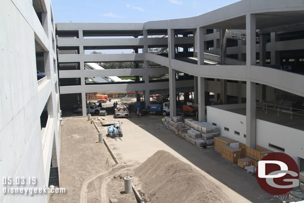 Landscaping work on the left and supplies staged on the right for the tram stop area.