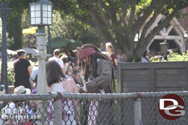 Spotted Captain Jack Sparrow signing autographs near the Rivers of America.