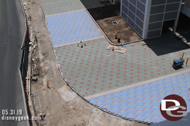 The curve looks to be for a re-enforced section of pavers leading to the gate.  Guessing it can be used as a driveway if needed.  Where as the sections of pavers under the awning do not have concrete under them.