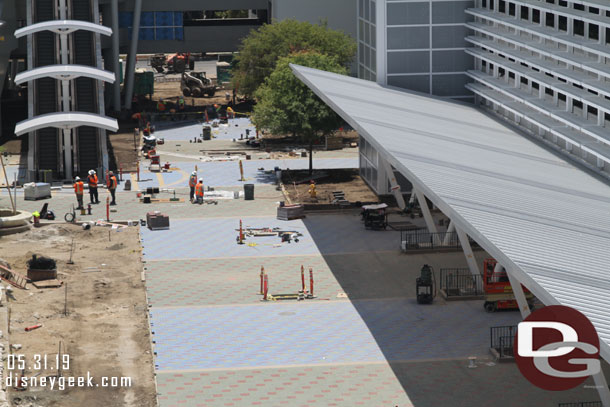 More pavers being installed in the distance.