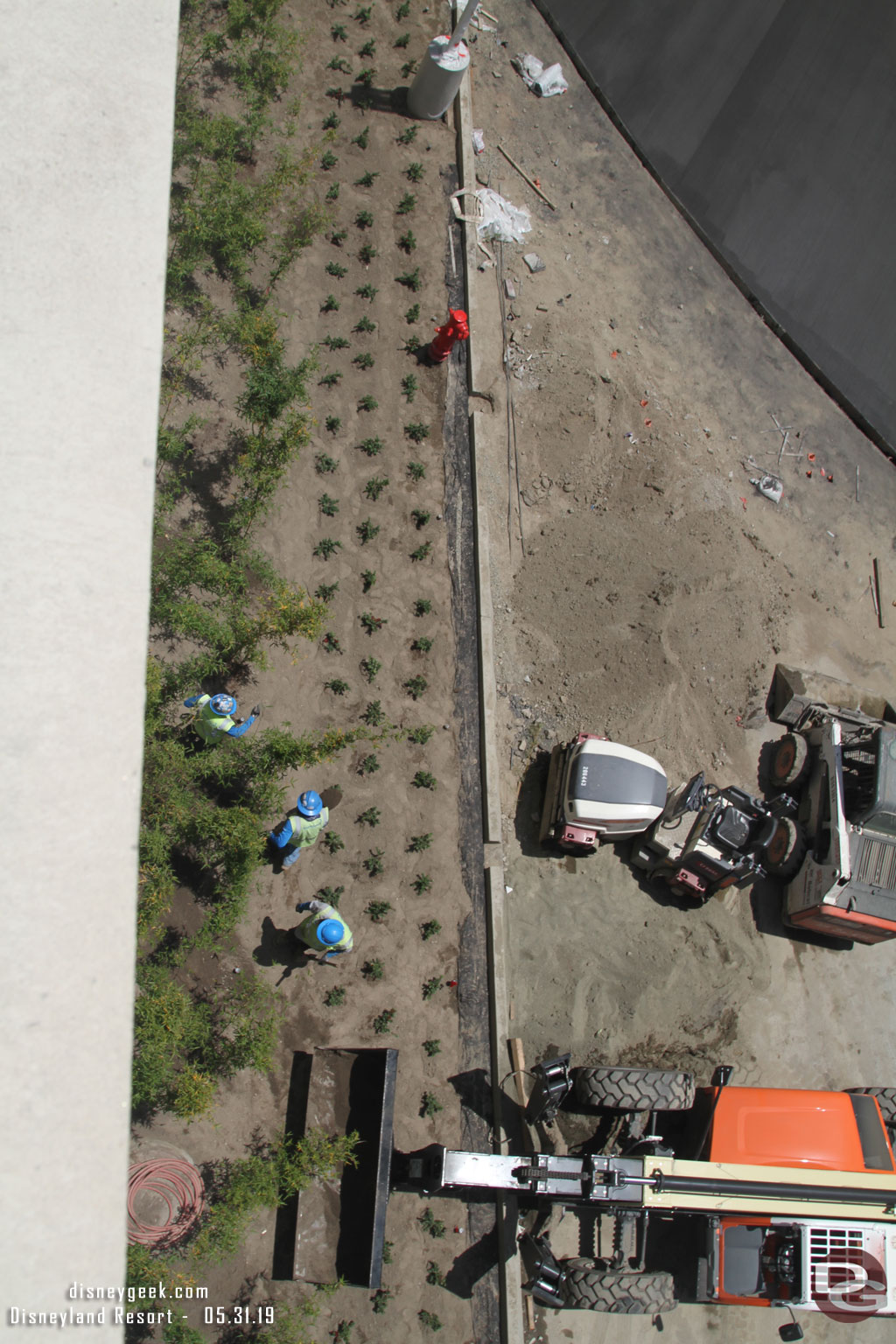 Down below landscaping work was underway between the two structures.