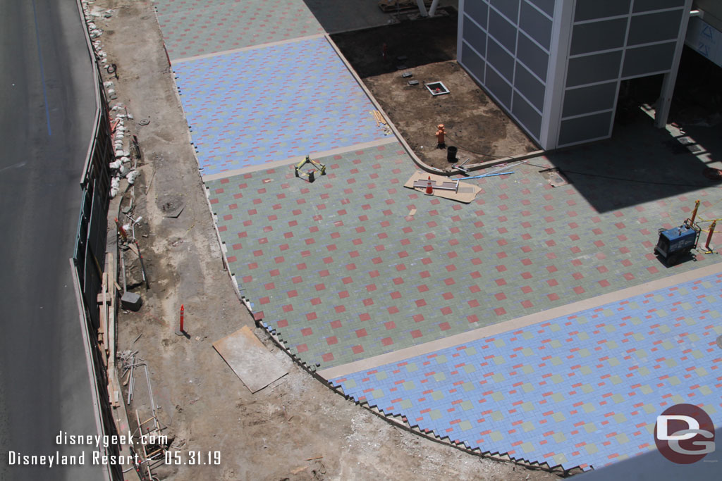 The curve looks to be for a re-enforced section of pavers leading to the gate.  Guessing it can be used as a driveway if needed.  Where as the sections of pavers under the awning do not have concrete under them.