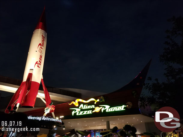 Alien Pizza Planet sign at night.  Looks like they still have some lighting to finish.