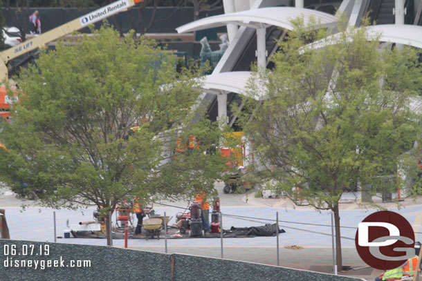 Teams working around the escalator bases.