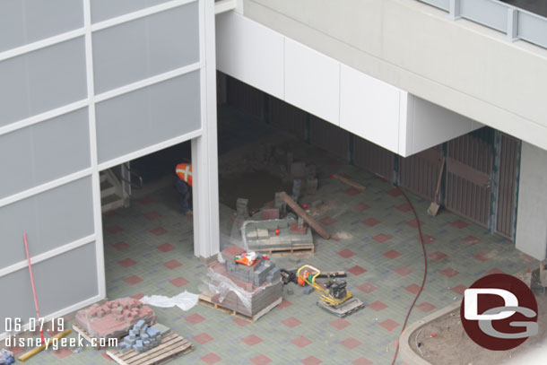 Finishing up the paver installation near the stairs.