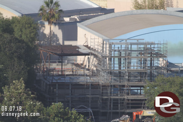 Starting on the left side.  Scaffolding is going up. In the background more steel and roof sections are being added.