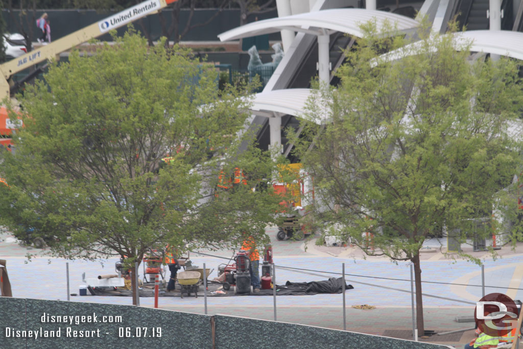 Teams working around the escalator bases.