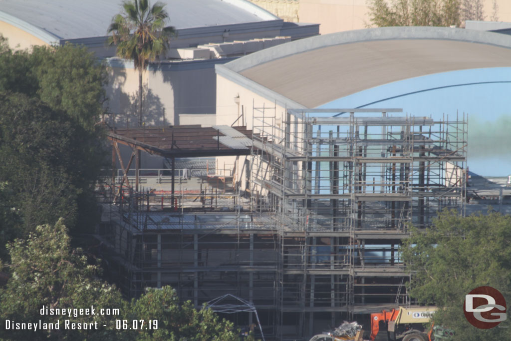 Starting on the left side.  Scaffolding is going up. In the background more steel and roof sections are being added.