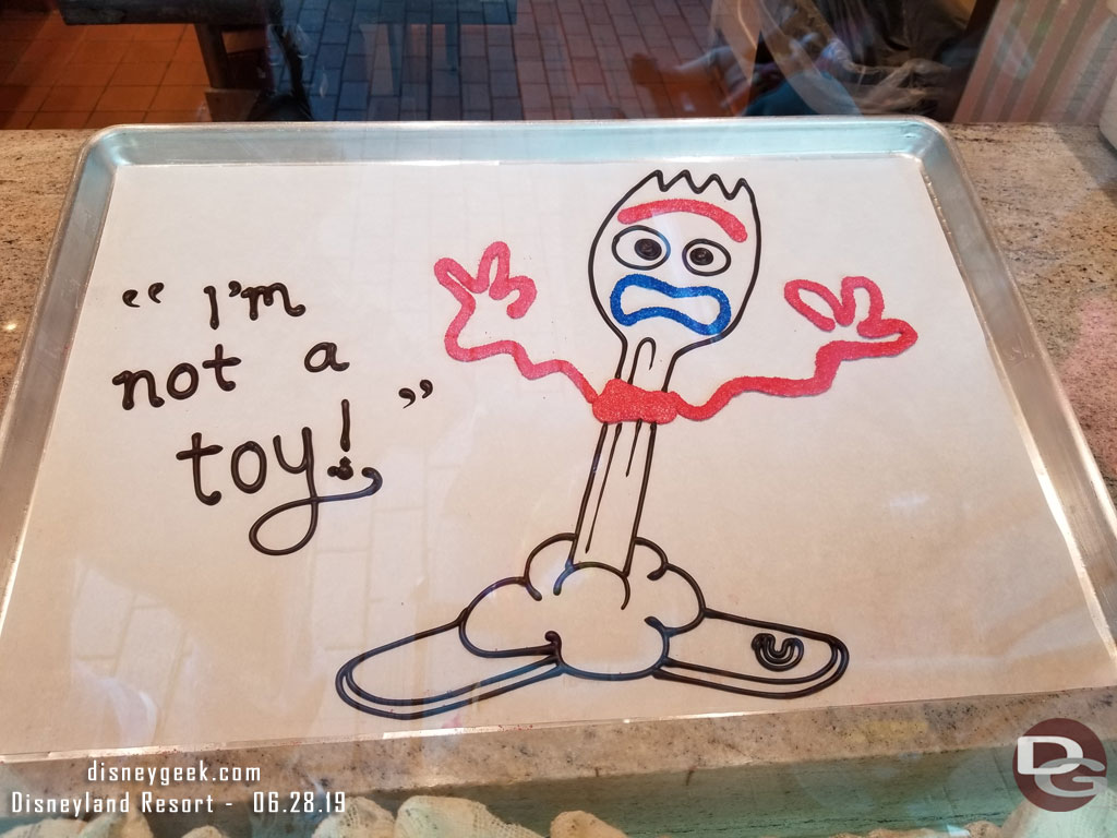 Forky in the Candy Palace window.