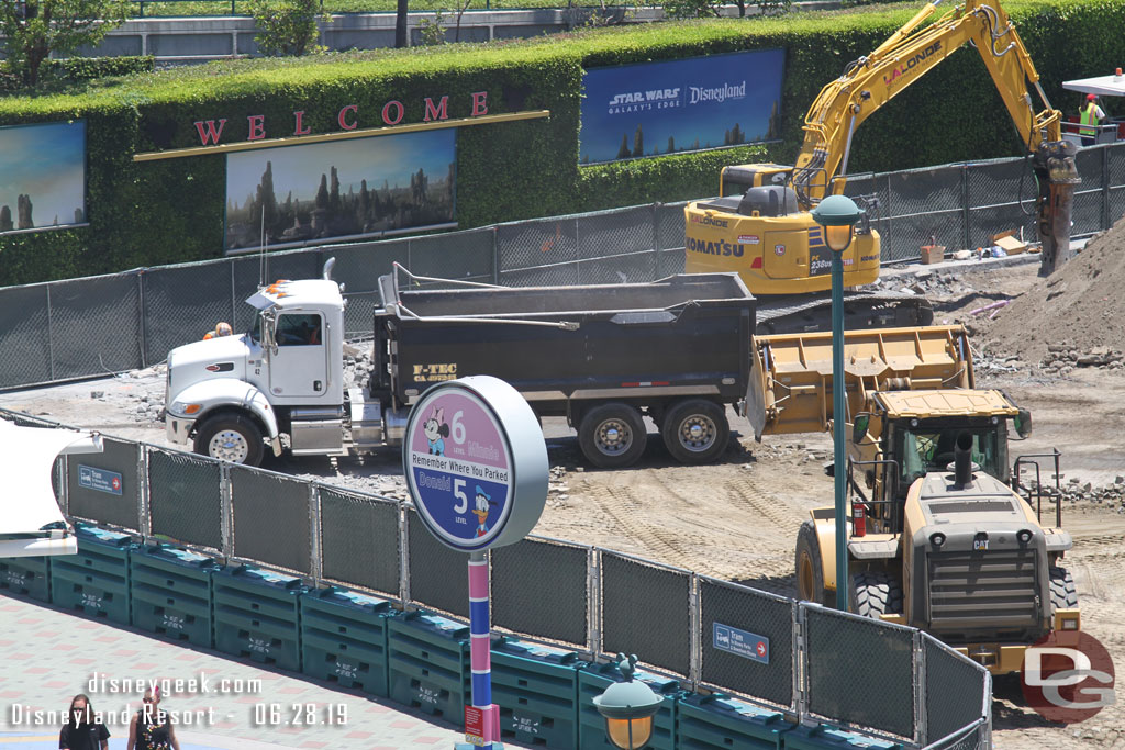 A parade of dump trucks were pulling in to hall away material.