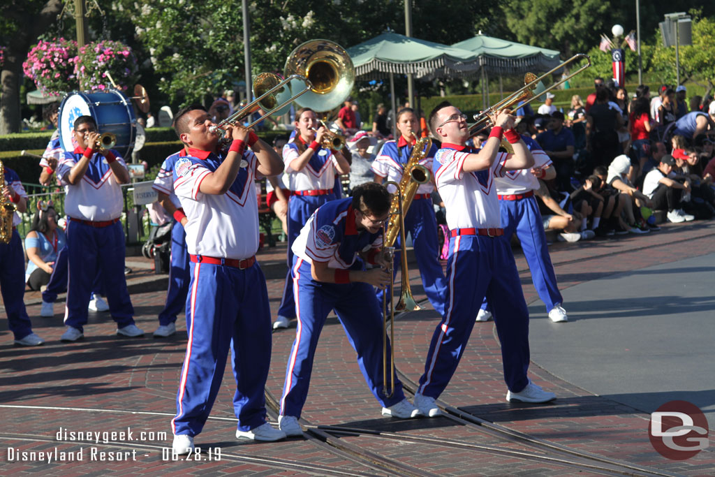 The band is one trombone player short today. He was in a wheelchair for the Flag Retreat, but for the marching sets he was unable to participate.