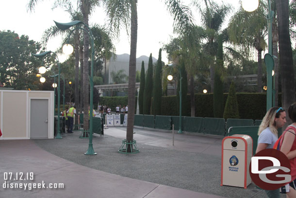 Cast Members starting to set up barriers to form a queue for the trams for this evening.