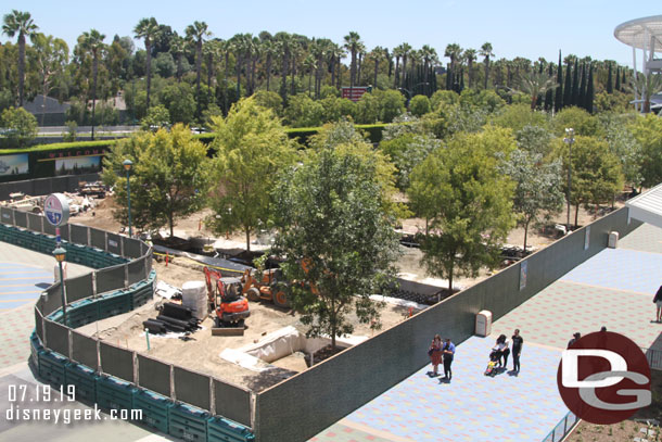 The forest in the tram plaza has grown since last week.  Trees are placed in the trenches nearest the Mickey and Friends parking structure now.