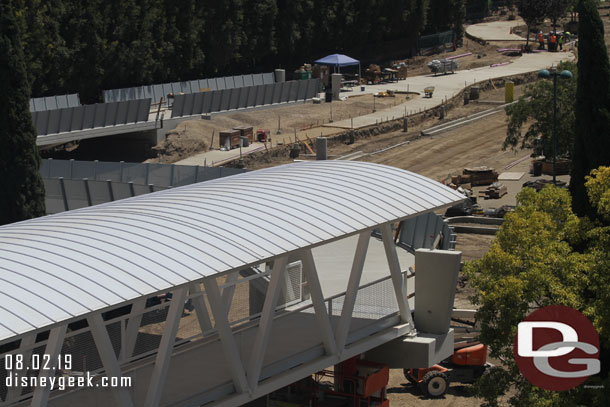 The side walls for the bridge ramp are being installed. You can see them going down the ramp to the left. 