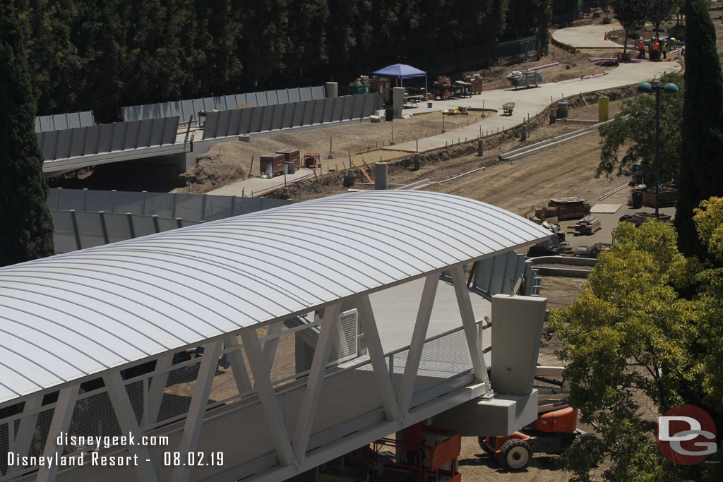 The side walls for the bridge ramp are being installed. You can see them going down the ramp to the left. 