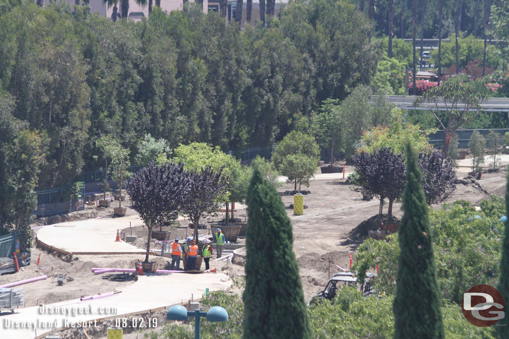 They are planting trees along the walkway.