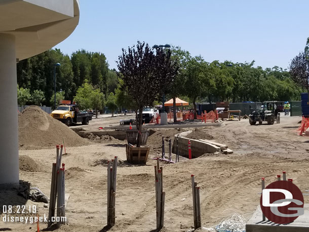 Trees being planted along the walkway and parking lot.