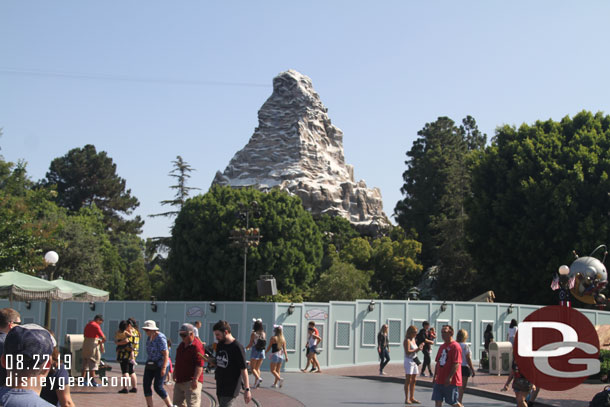 Walls are up around part of the Tomorrowland entrance as they work to remove the curb around the hub and the rock work from the land's entrance.