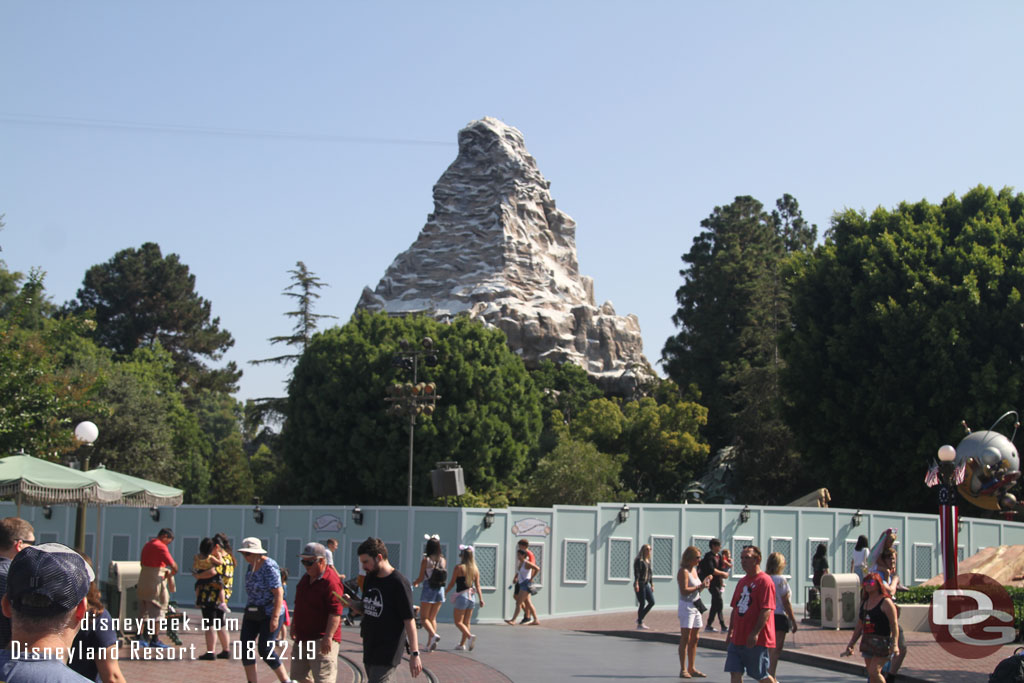 Walls are up around part of the Tomorrowland entrance as they work to remove the curb around the hub and the rock work from the land