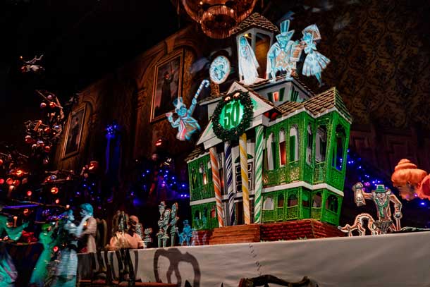 Here is the Disney Released photo of the house - 

The Haunted Mansion transforms into Haunted Mansion Holiday for Halloween Time and the holiday season, inspired by the Walt Disney Pictures classic Tim Burton's The Nightmare Before Christmas.” As part of the transformation, a gingerbread house sits on the dining table in the Grand Hall as the scent of tasty gingerbread fills the air. This year, the nearly 10-foot tall centerpiece celebrates the Haunted Mansion's 50th anniversary, complete with 15 spirited Haunted Mansion residents made of gingerbread cookies. (David Nguyen/Disneyland Resort)