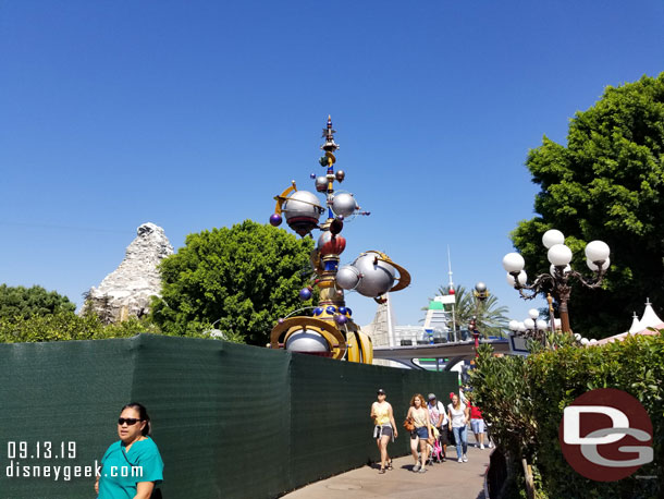 More walls as you head toward Tomorrowland.  The south side of the entrance is now behind walls for the removal of the rocks and other pavement work.