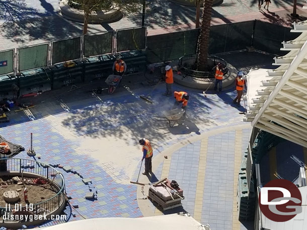 Adding sand to lock in the pavers.