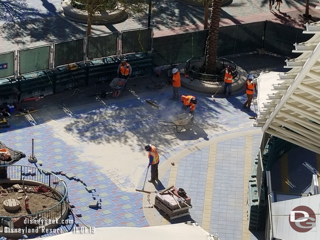 Adding sand to lock in the pavers.