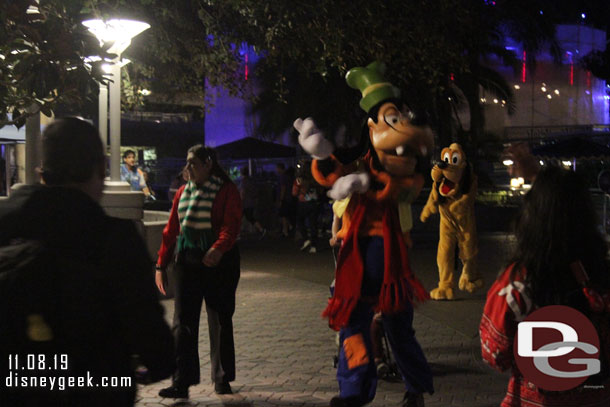 Goofy and Pluto arriving for the Holiday Dance Party in Tomorrowland.